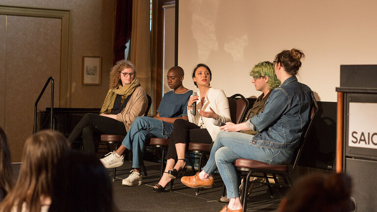 VCS Students in conversation on an SAIC stage.