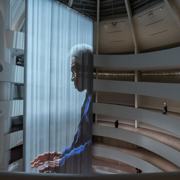 A projected image of a person in the Guggenheim museum in New York.