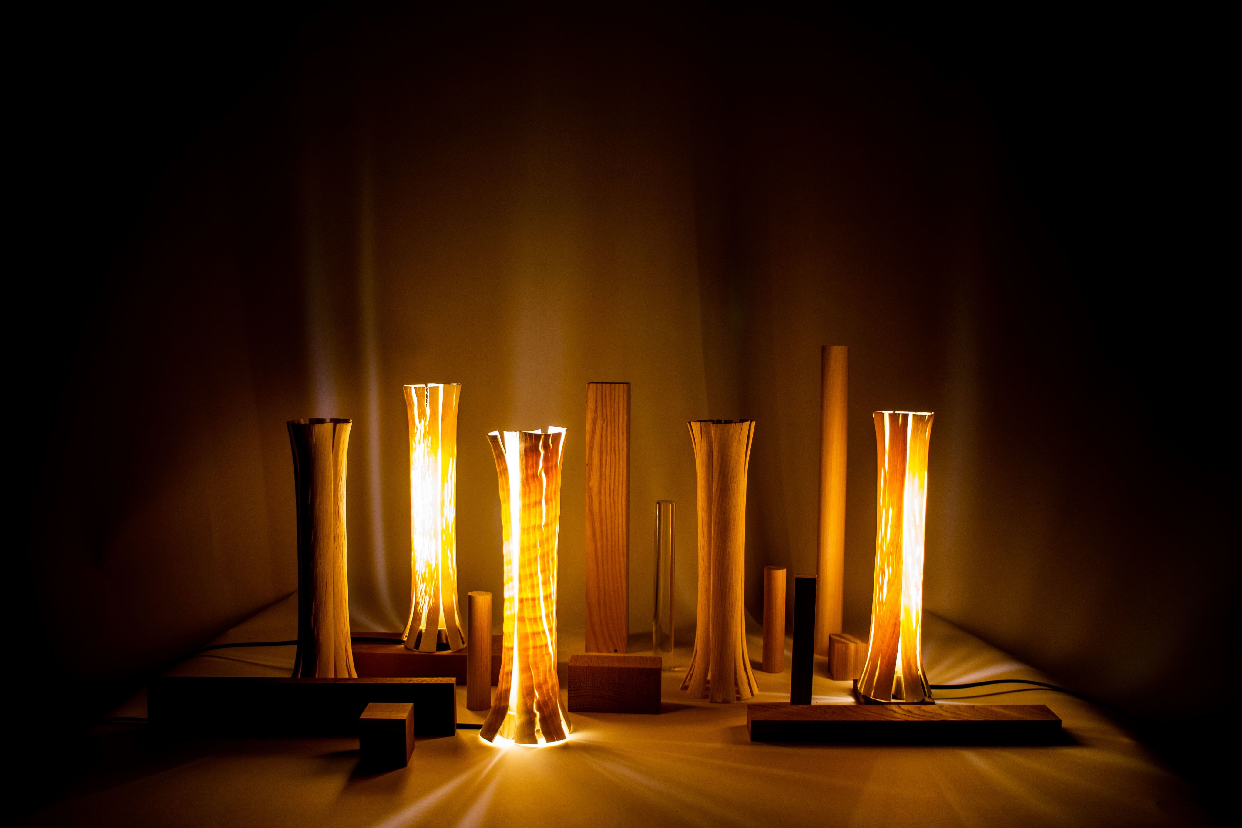 Wooden sculptures lit in a dark room