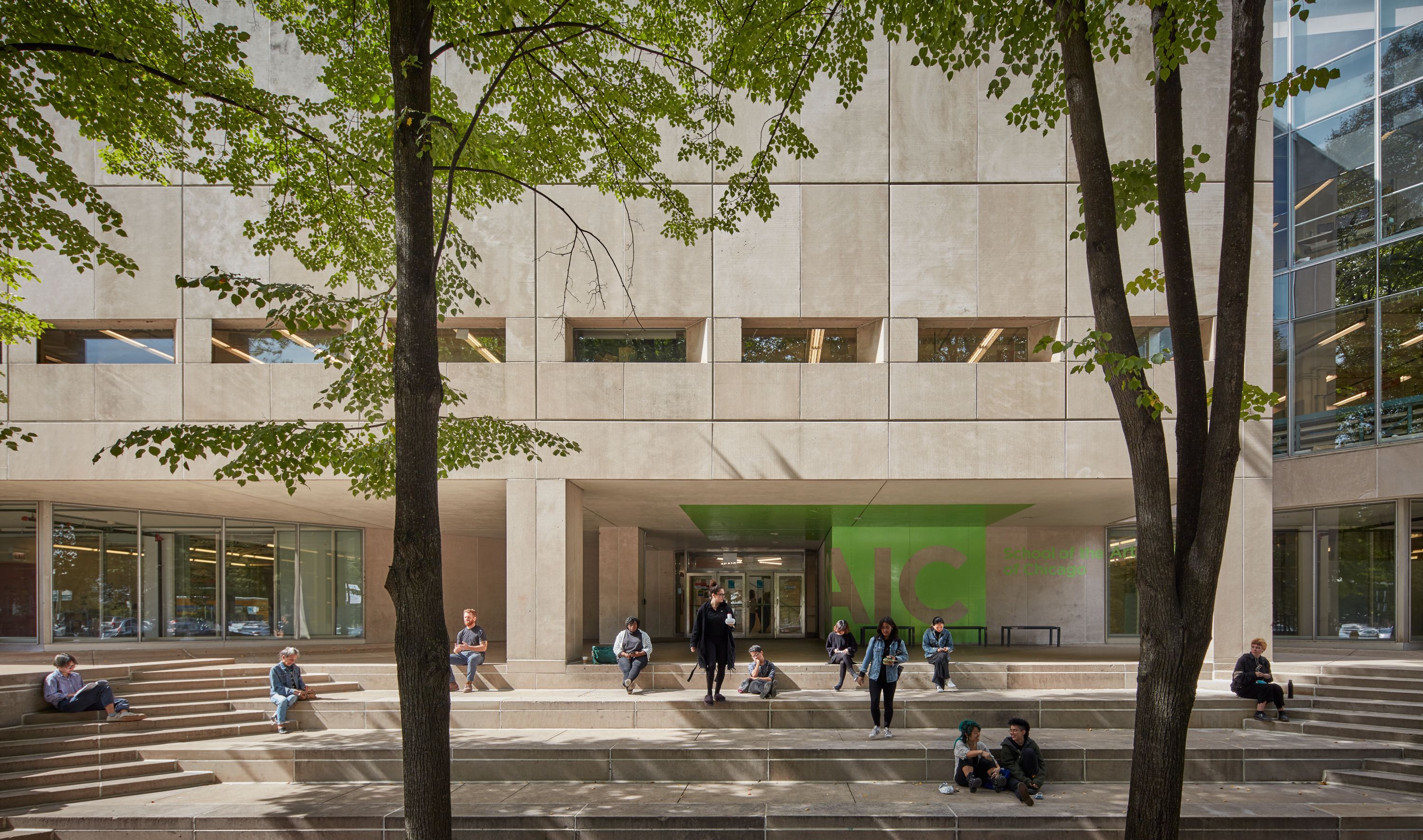 Students sitting on steps in front of the 280 Building