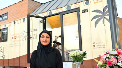 Almansoori standing in front of her mobile art studio Kenaz.