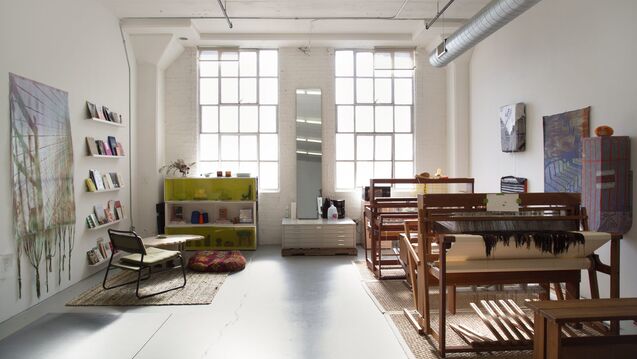 A well lit weaving studio with tall ceilings and high windows