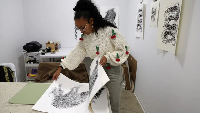 Camille Billie looks over her prints at the Indigenous Futures Center