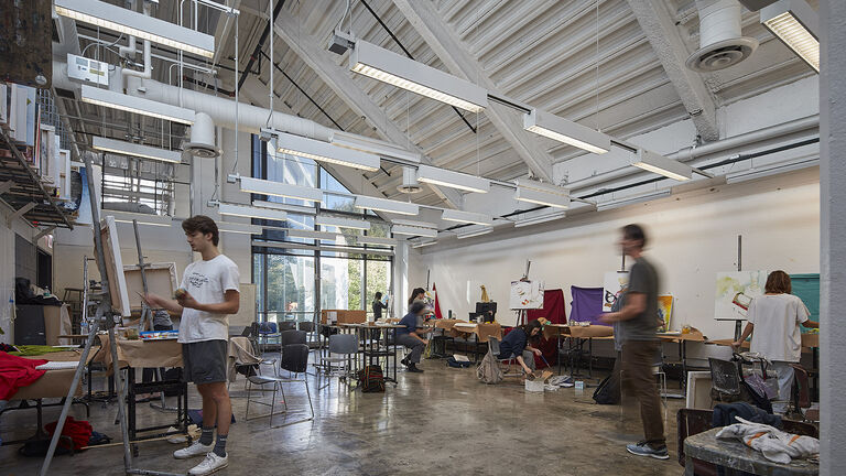 Interior shot of a painting studio with students.