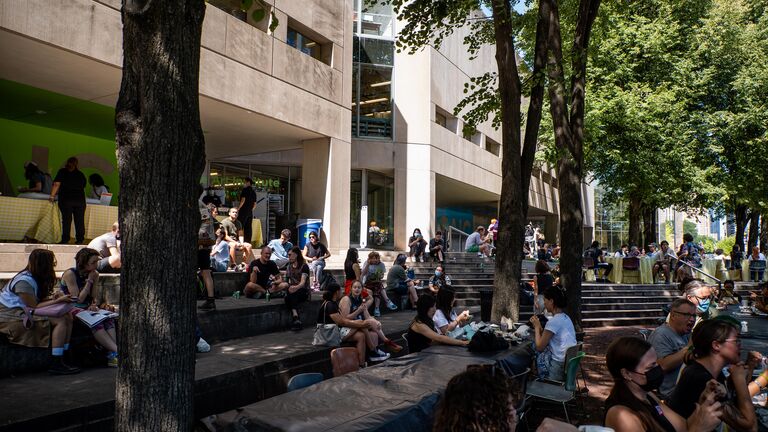 A large group of students congregate in the pit outside 280