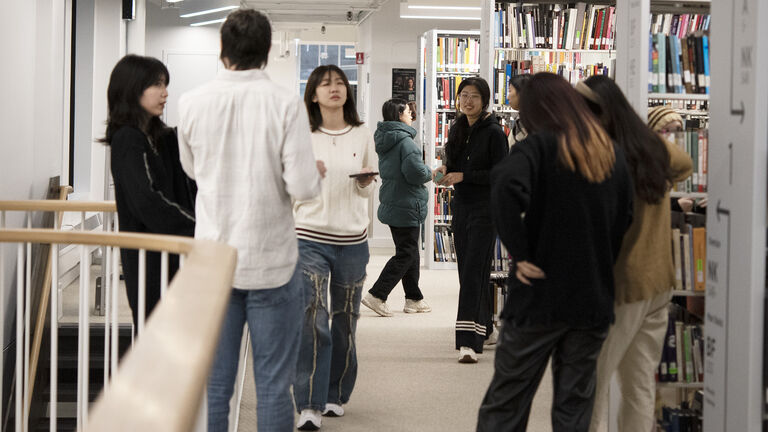 Students standing in a library