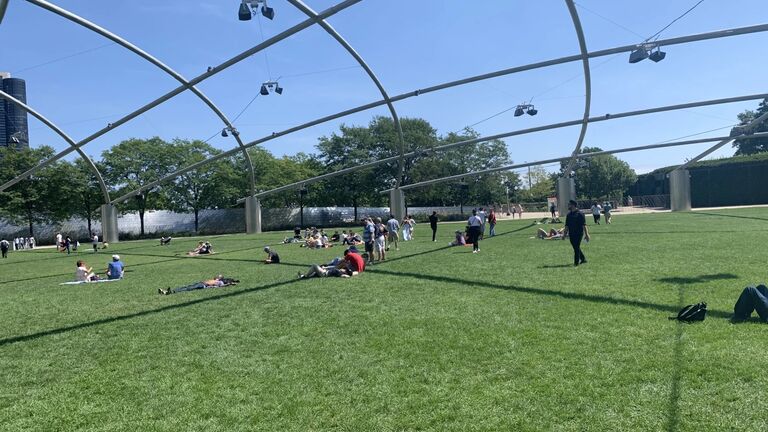 An image of the Pritzker Lawn of viewers engaging with the sound installations. 