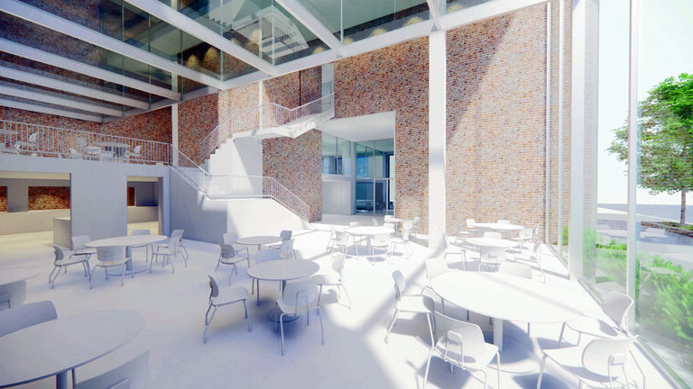 A photo of a large room with windows, brick walls, white floors, white tables, and white chairs