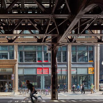 Exterior image of students entering and leaving SAIC’s Sharp Building.