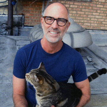 Image of faculty member Steve Reber and a cat.