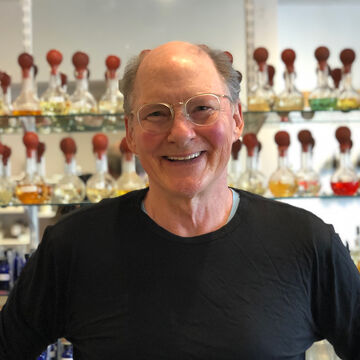 A portrait of Tedd Neenan wearing a black shirt. 