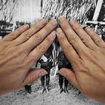 Two hands covering a black and white photo