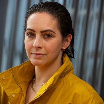 Headshot of a white woman against a muted background