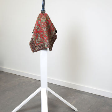 A piece of fabric draped over a four-legged wood structure, by Rex Delafkaran