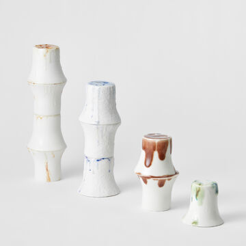 Four ceramic pieces by Christina Lee varying in color and descending in height