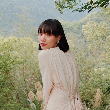 Three quarters turn photograph of Tzu Ying Cheng overlooking trees