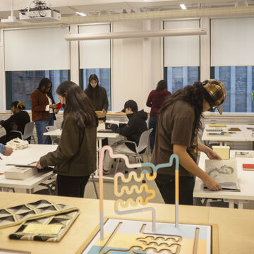 A photo of multiple students at the SAIC library.