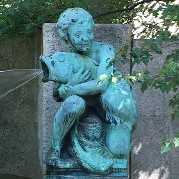 The Fountain of the Great Lakes with a sculpture of a boy holding a dolphin