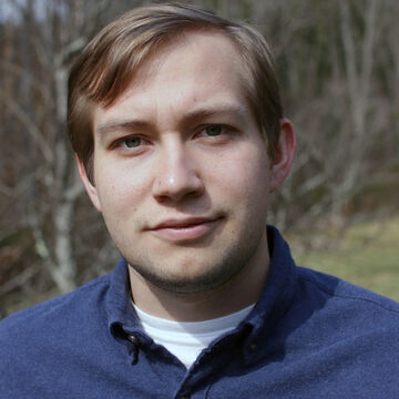 Headshot of an adult white man standing outdoors