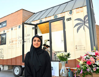 Almansoori standing in front of her mobile art studio Kenaz.