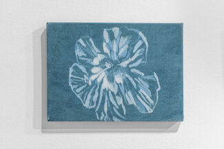 A monochromatic blue painted artwork of a flower