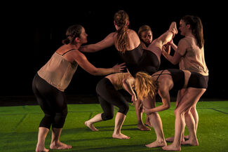 Six dancers engaged in intimate choreography