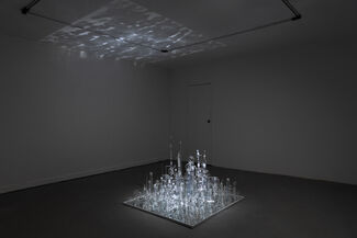 A glass art installation in a dark room