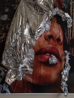 Photograph installation by Cecil Mcdonald, Jr. of a face obscured by pieces of foil 