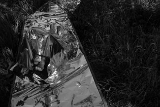 Black and white photo by Cecil McDonald, Jr. of foil laid in grass. 