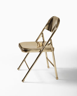 A bronze folding chair