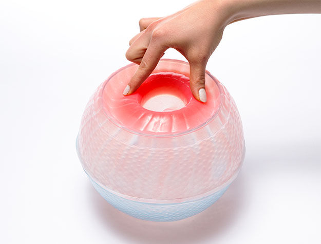 Image of a hand touching a spherical glass object.