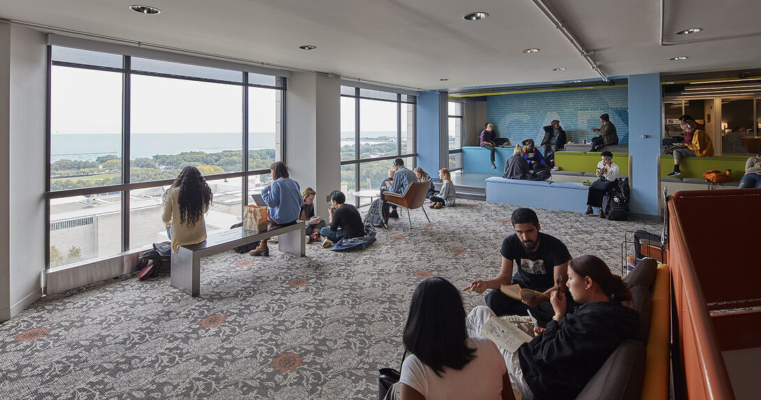 Interior shot of students gathered around the lounge outside CAPX offices.