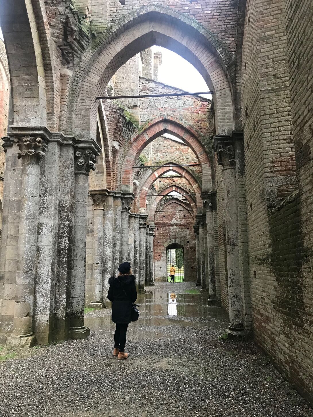 A student standing outside in an old building. 