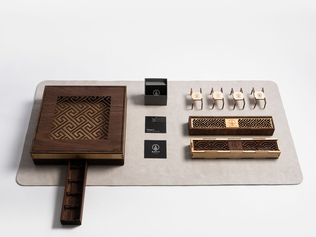 A designer utensil box that includes a set of cutlery, a custom leather mat, napkins, and bespoke packaging.