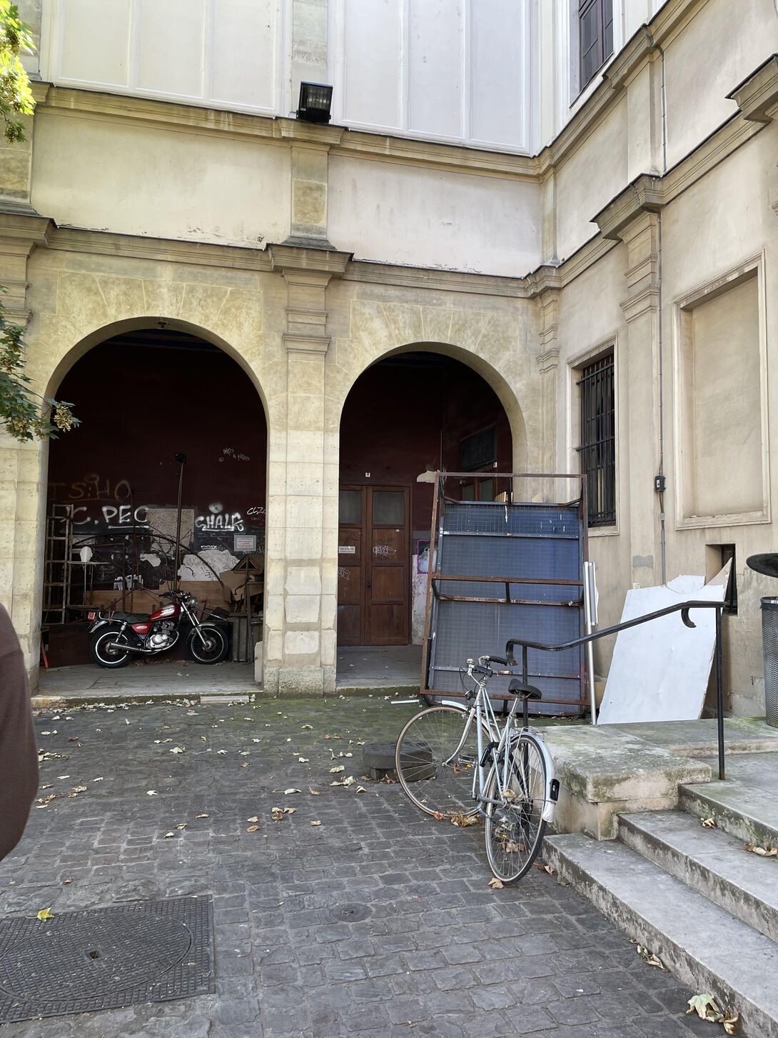 A Parisian courtyard with a bicycle leaning against the railing.