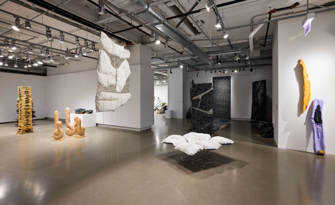 An image of art hanging from the ceiling in a gallery.