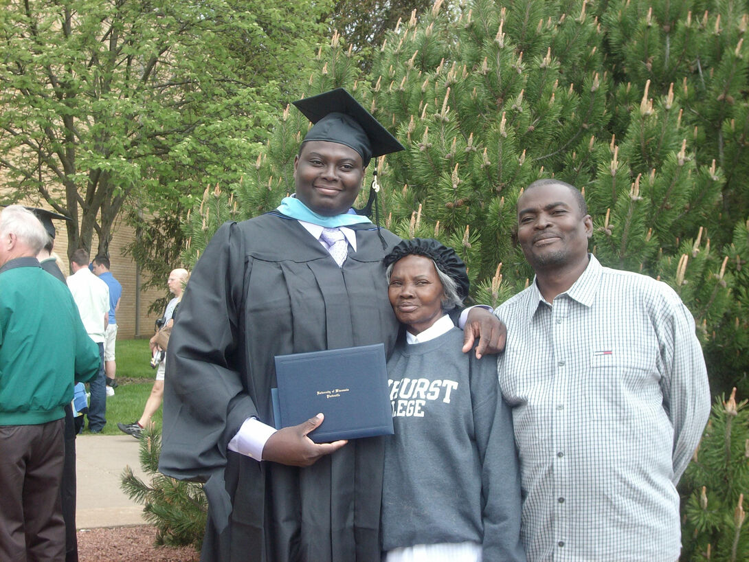 Karl Constant in graduation robes with his parents 