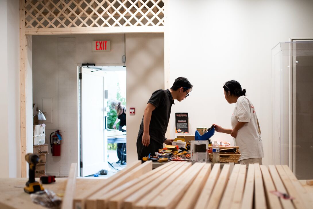 Soo Kim supervises the construction of a pavilion in the KCCoC 