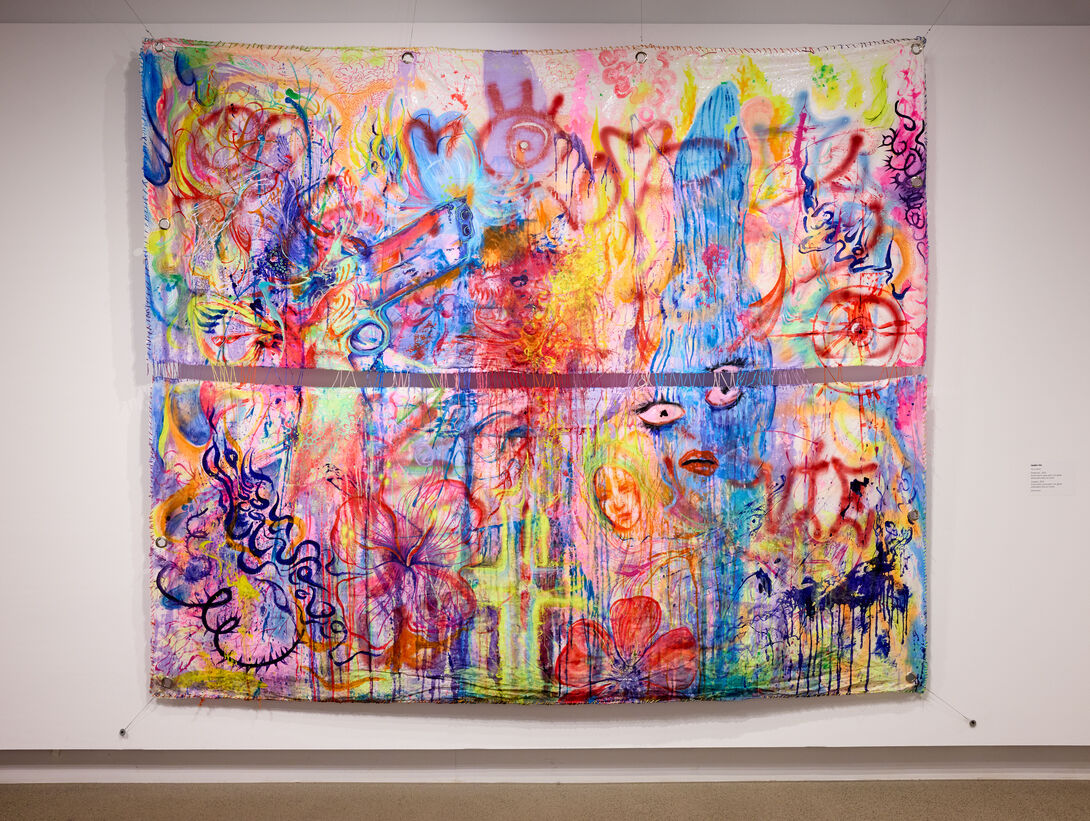 A large abstract painting with bright oranges, pinks, yellows, and blues.